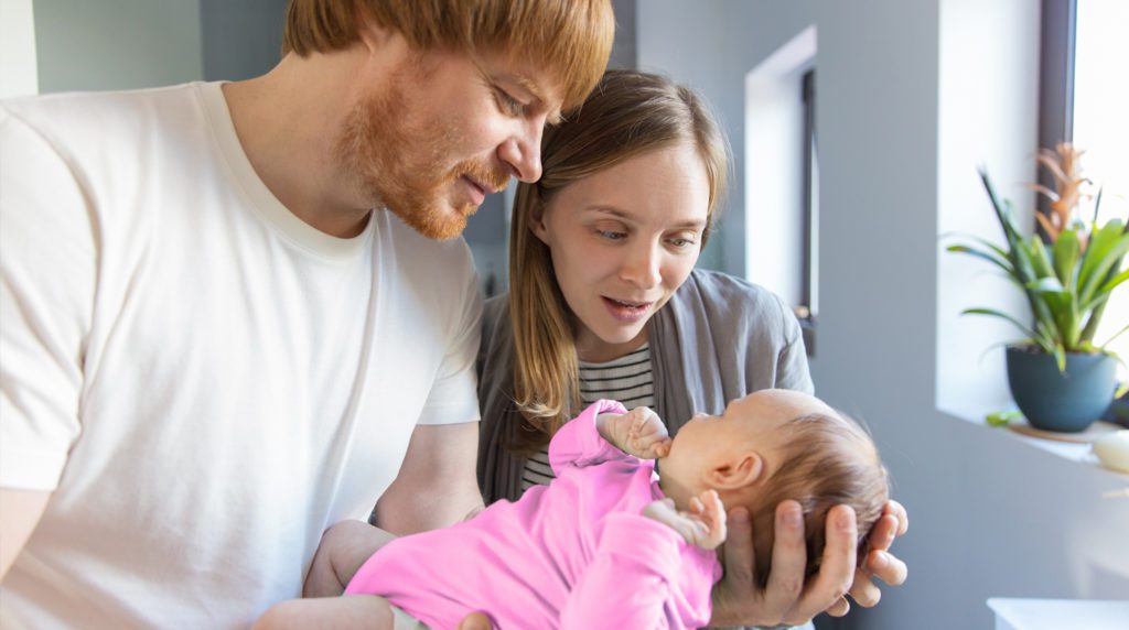 Couple stares lovingly at their baby girl