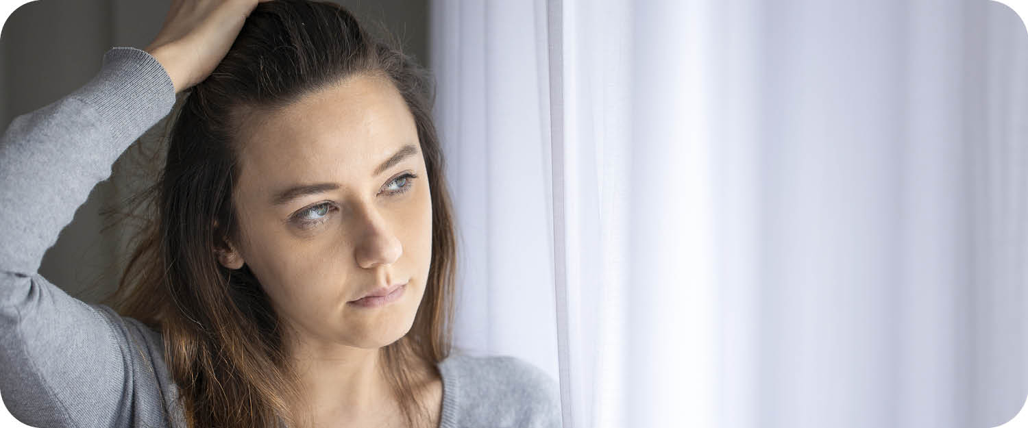 Distressed woman with hand in hair