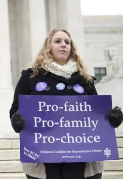 woman holding pro-faith, pro-family, pro-choice sign at protest in front of nation's capitol