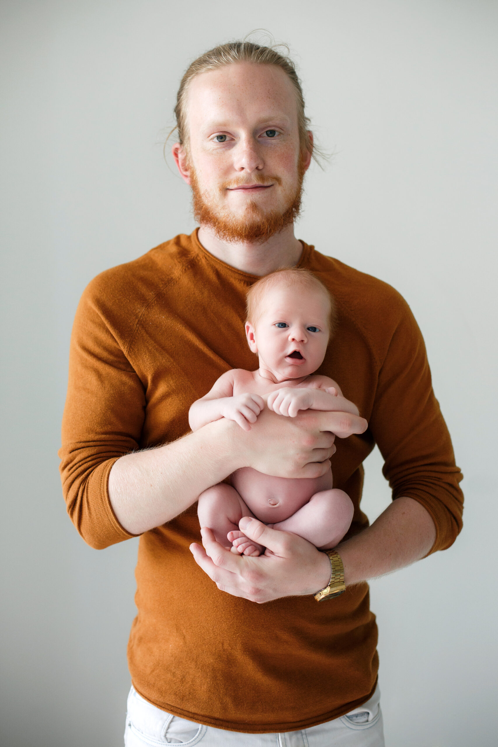 Closeup Portrait Of Young Bearded Caucasian Father Hugging And K young white man holding infant